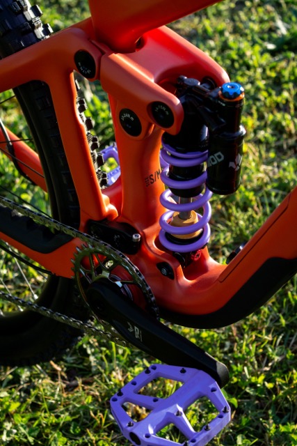 Purple coil shock and crankset of the terracotta Crewkerz Destiny enduro MTB.
